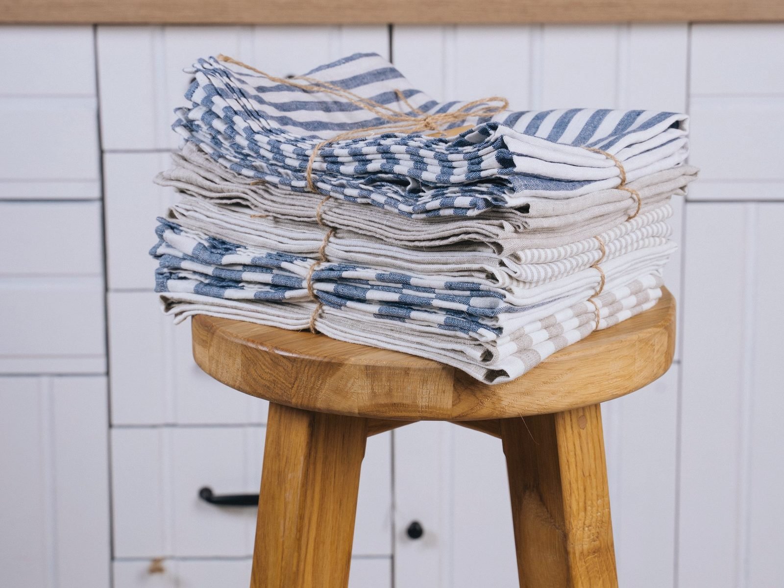 Tied bundles of striped and plain towels stacked and ready for delivery