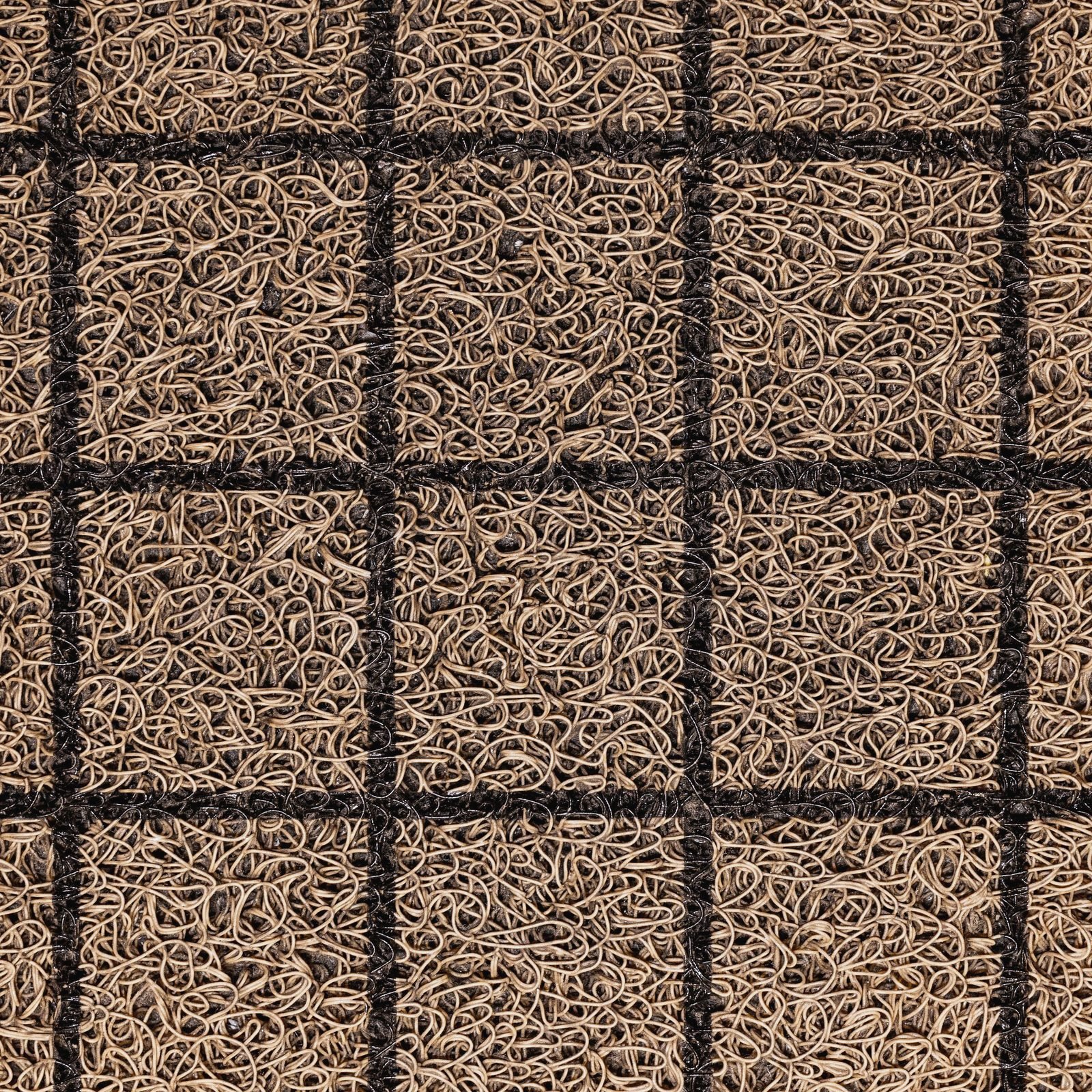 Close-up of a coir entrance mat with a moulded grid