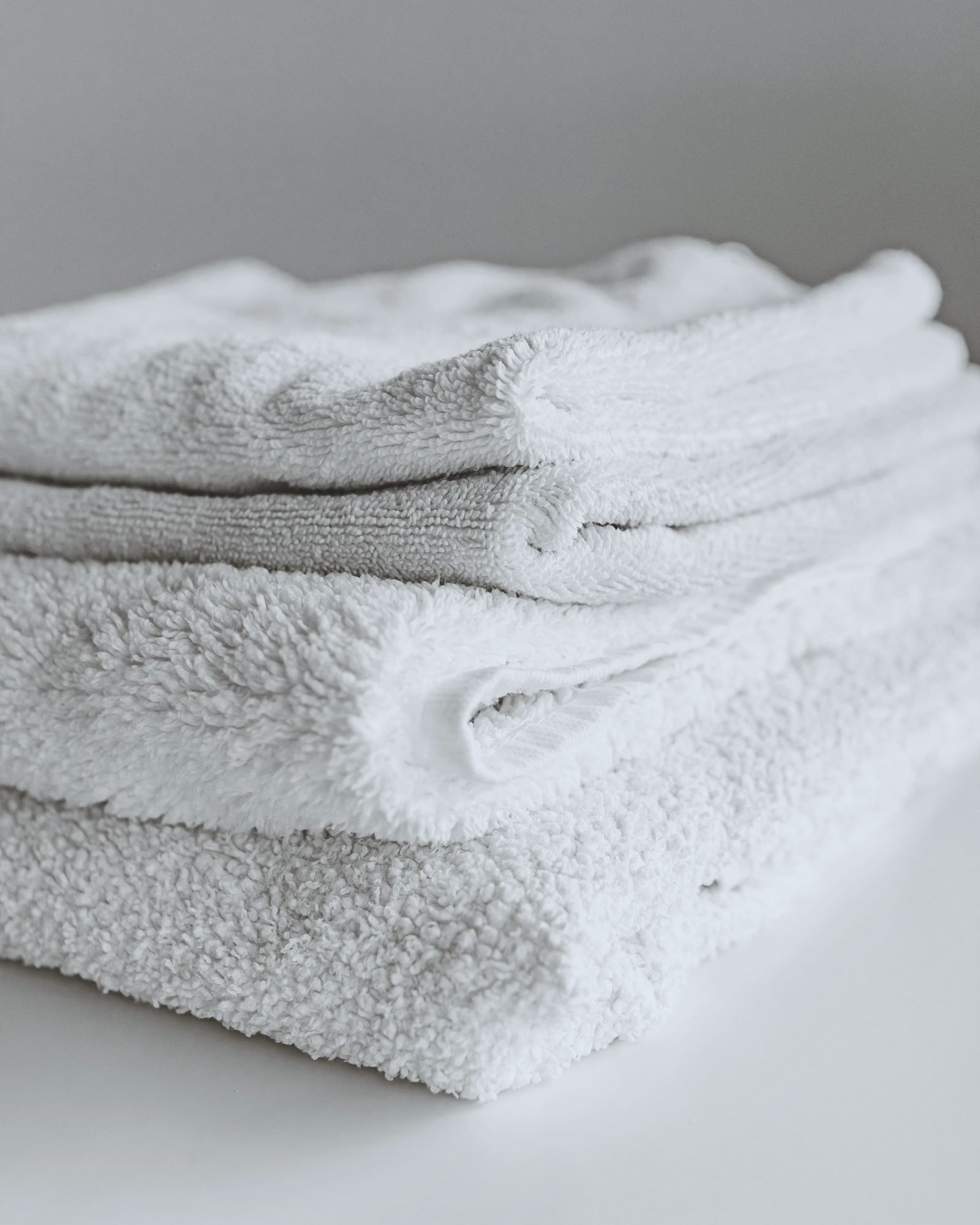 Laundered white towels in a neat stack